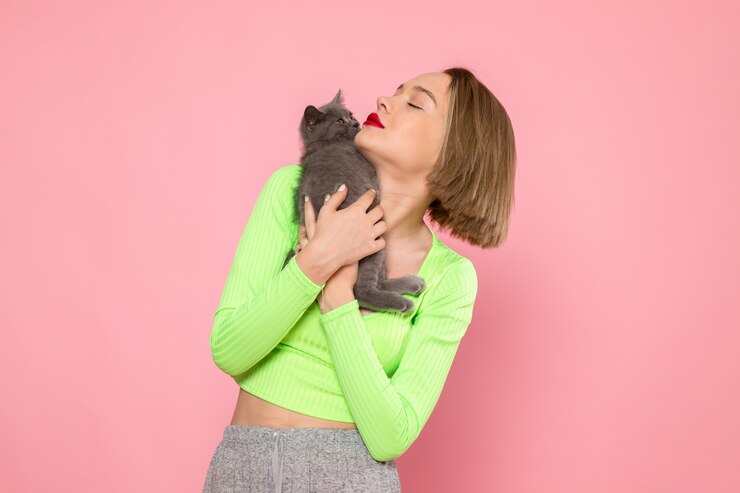 young woman green shirt grey trousers holding cute grey kitten 140725 25260