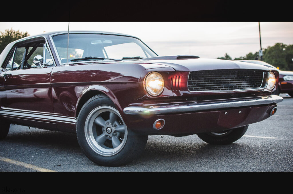 old red american car stands street evening