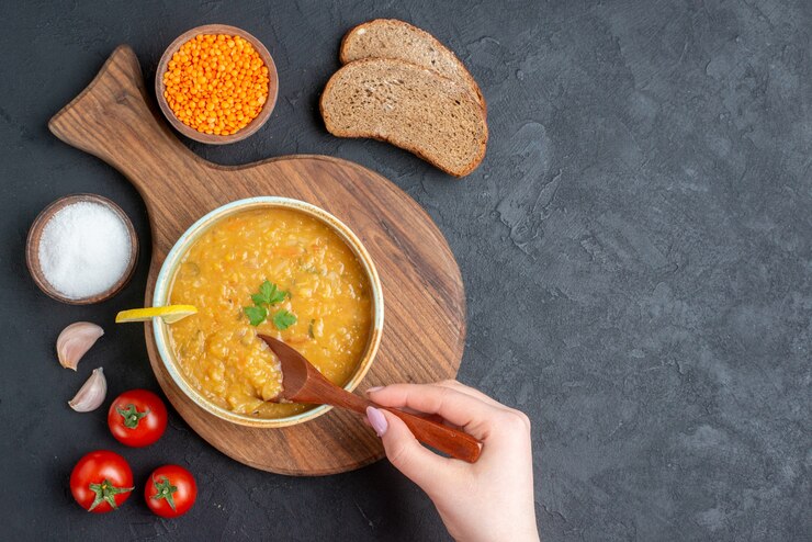 top view lentil soup with salt tomatoes dark bread loaves dark surface 179666 35288